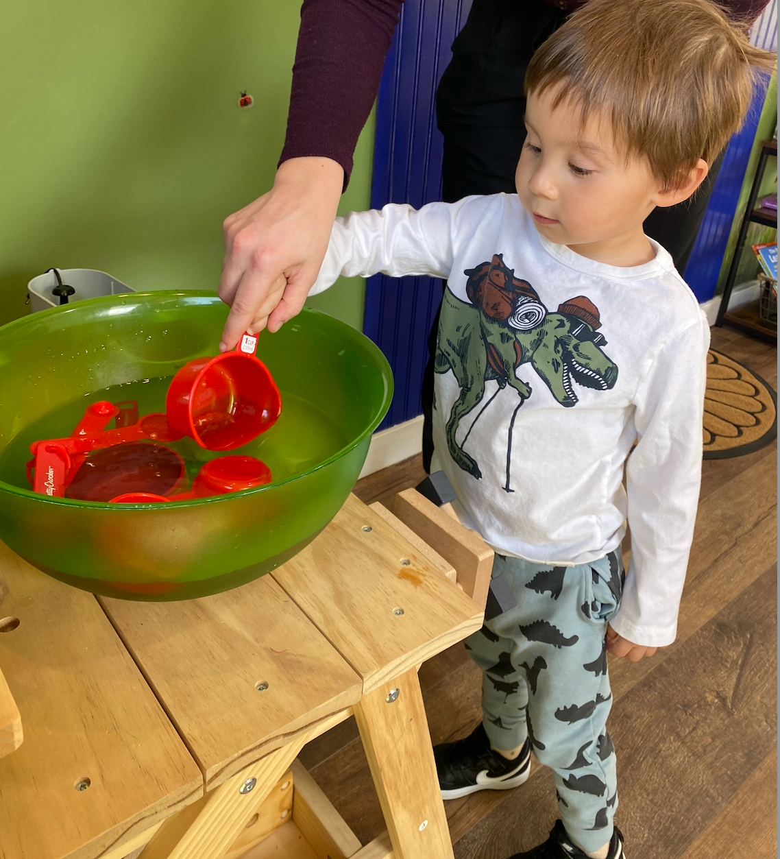 Child engaged in hands-on water play at the center