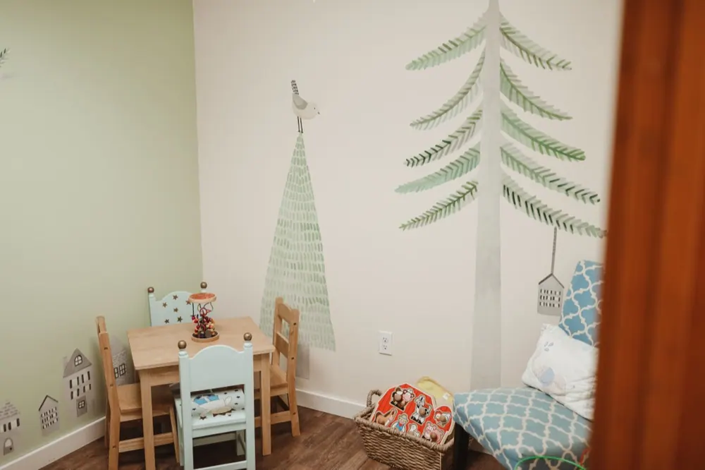 A child-sized table and chairs in a play room at Traina Behavioral