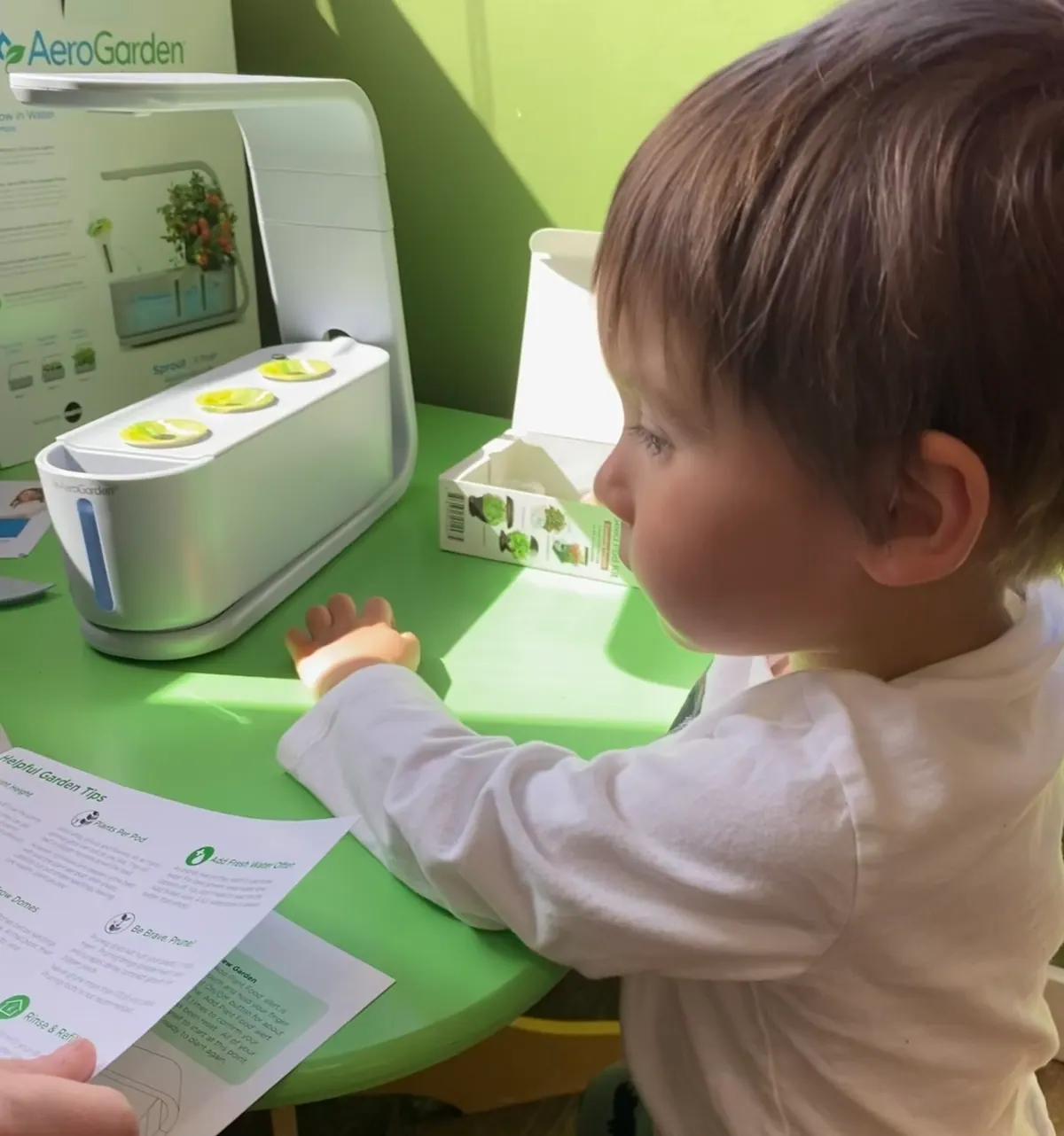 A young child focused on an early learning activity at the Traina center